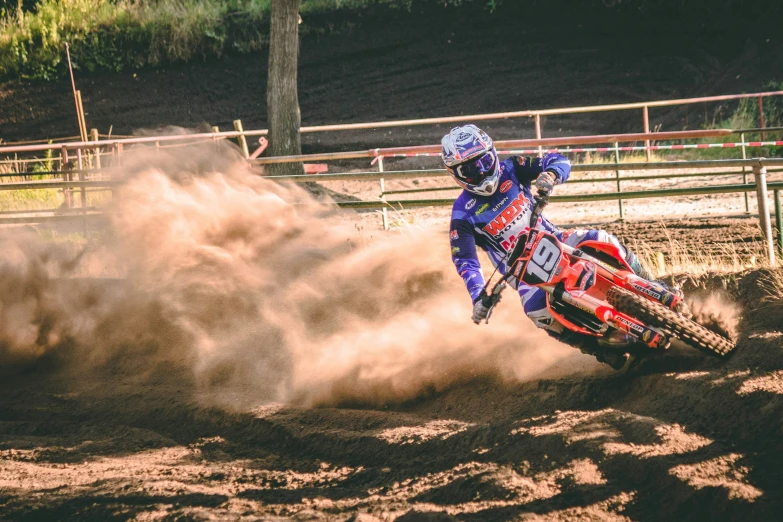 a person on a dirt bike riding through the sand