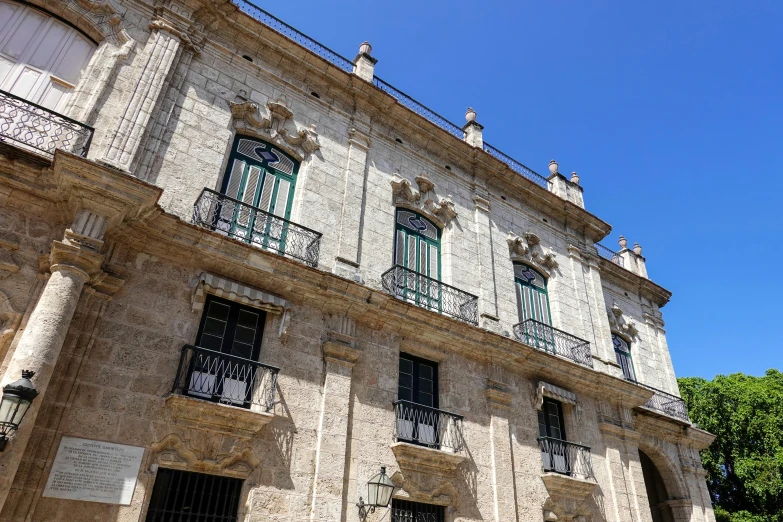 a building with two stories with balcony and balconies