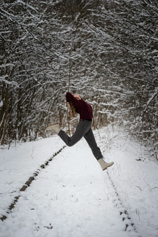 a girl wearing red and black is in the snow