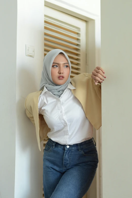 a woman posing in jeans and a white top