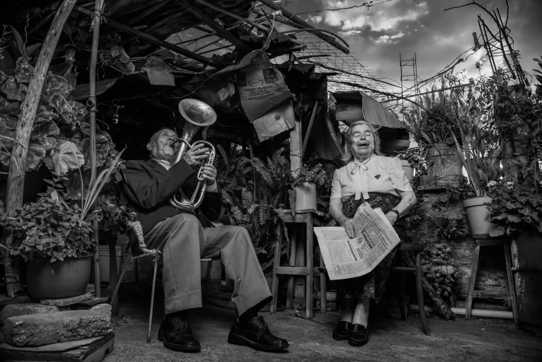 a black and white po of two people holding musical instruments