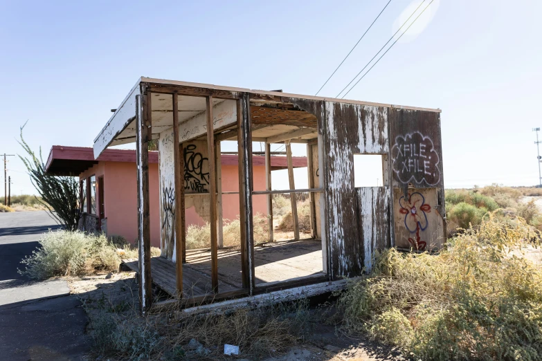 a broken out building on a dirt road