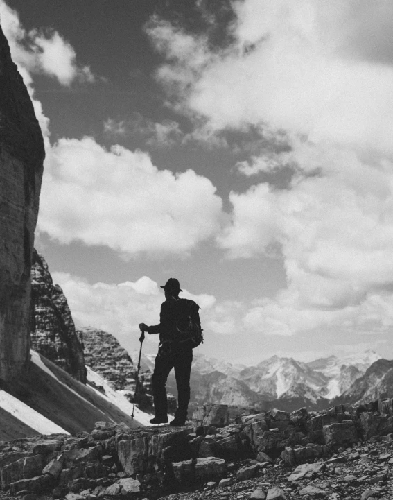 a man standing on top of a snow covered hill