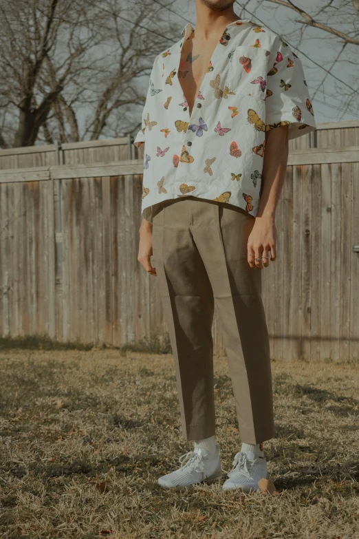 a man with a beard standing in the grass