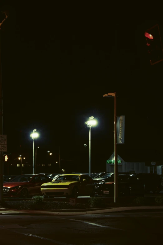 a night scene with many parked cars and streetlights