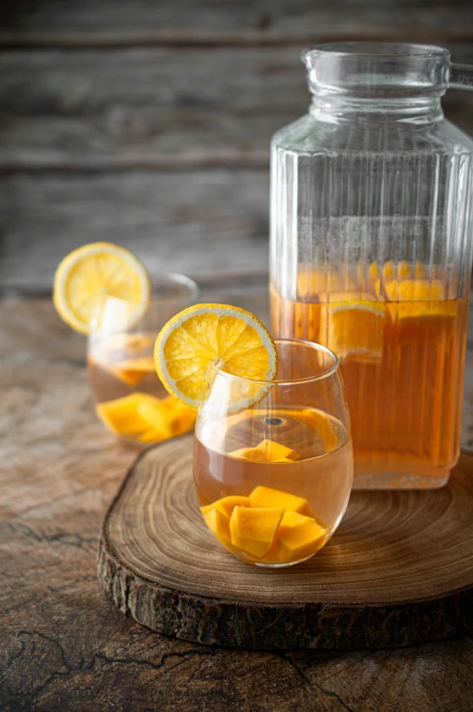 two glasses with lemon tea and an jug of water