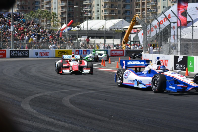 three cars on an asphalt race track next to each other