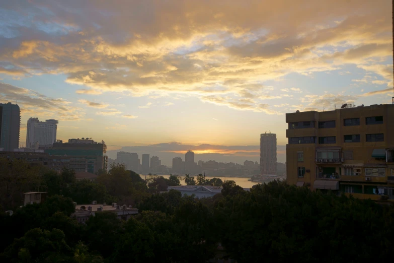 a sunset view looking over a city to the water