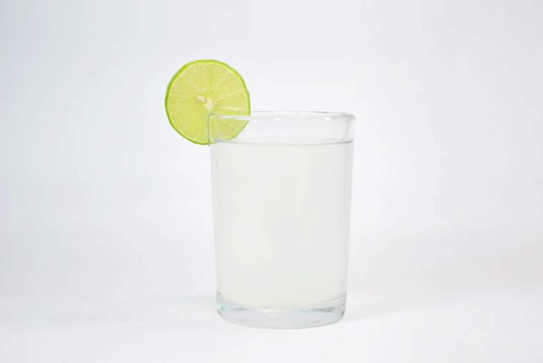 there is a lemon slice in a glass of water