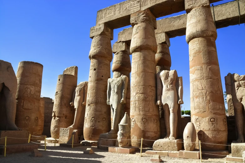 a giant stone statue with several pillars in front of it