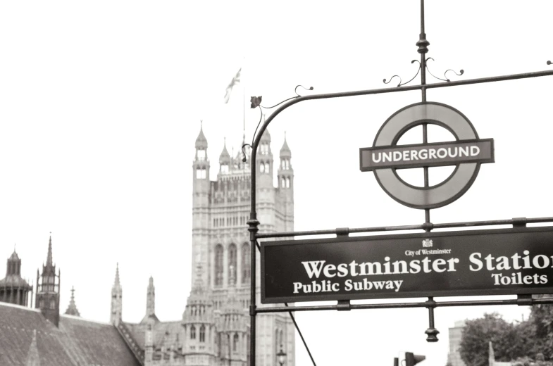 the westminster tower and the underground sign as seen from the train station