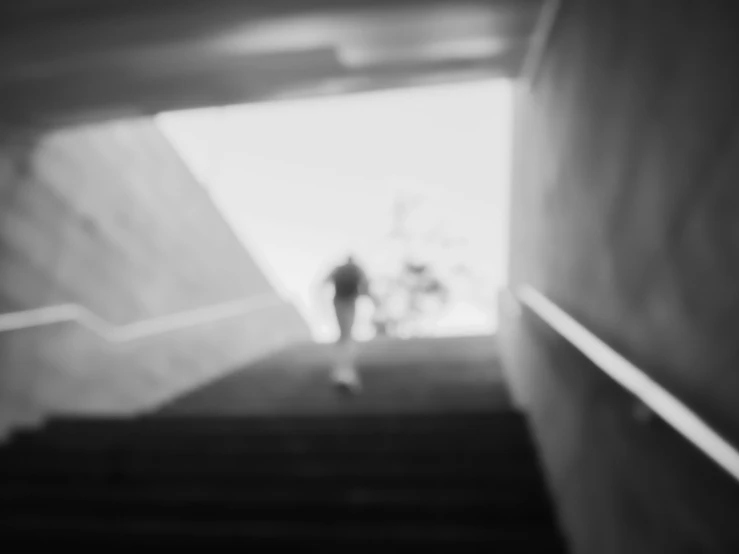 a person walking up the stairs in a dark building