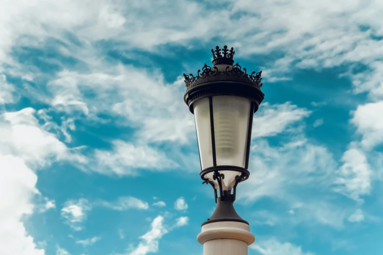 an old - fashioned street light stands on a pole