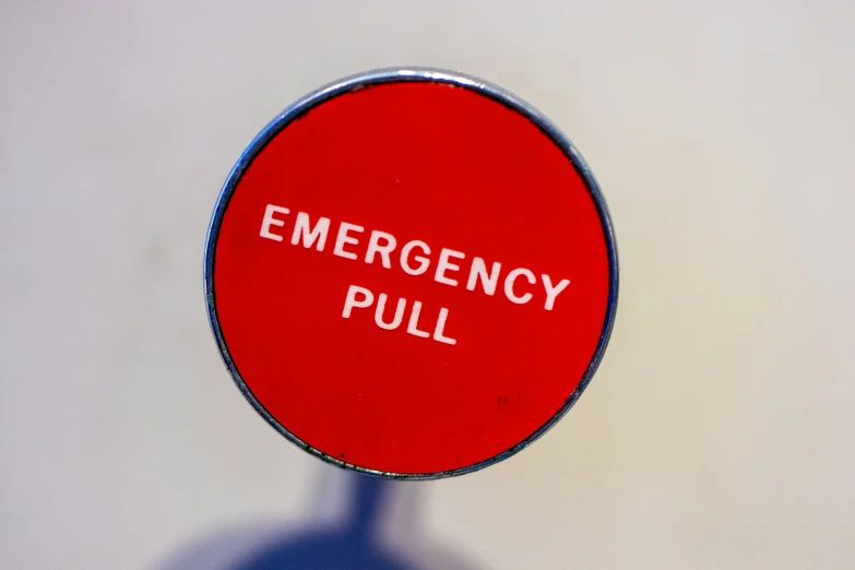 a red emergency pull sign with the words emergency pulled on it