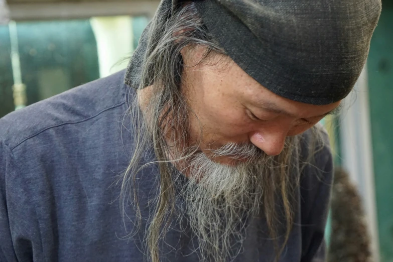 a man wearing a hat and looking at his cellphone