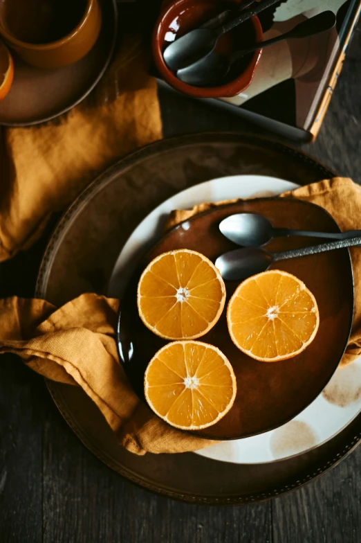 a plate topped with sliced orange slices and coffee cups