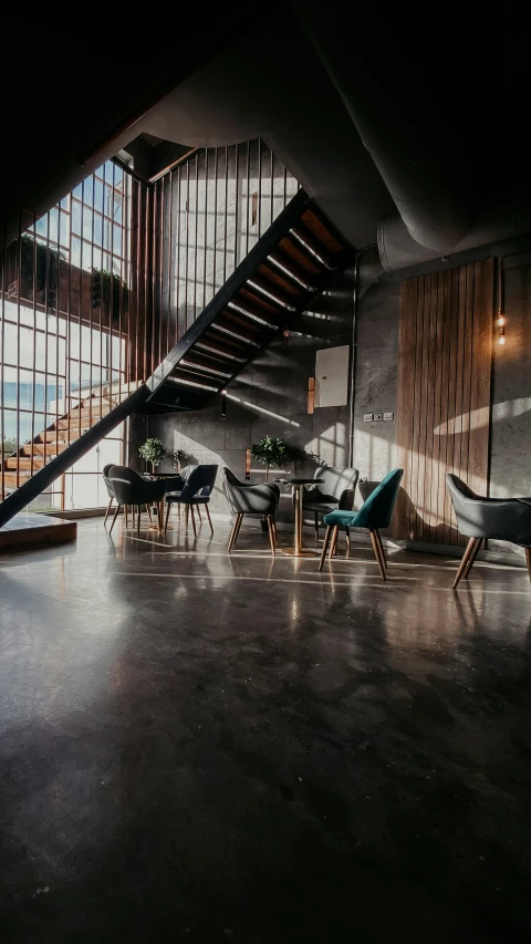 a long metal staircase with chairs and tables in it