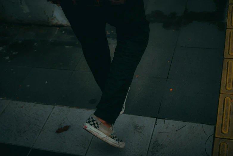 a person is standing on the sidewalk with their shoes off