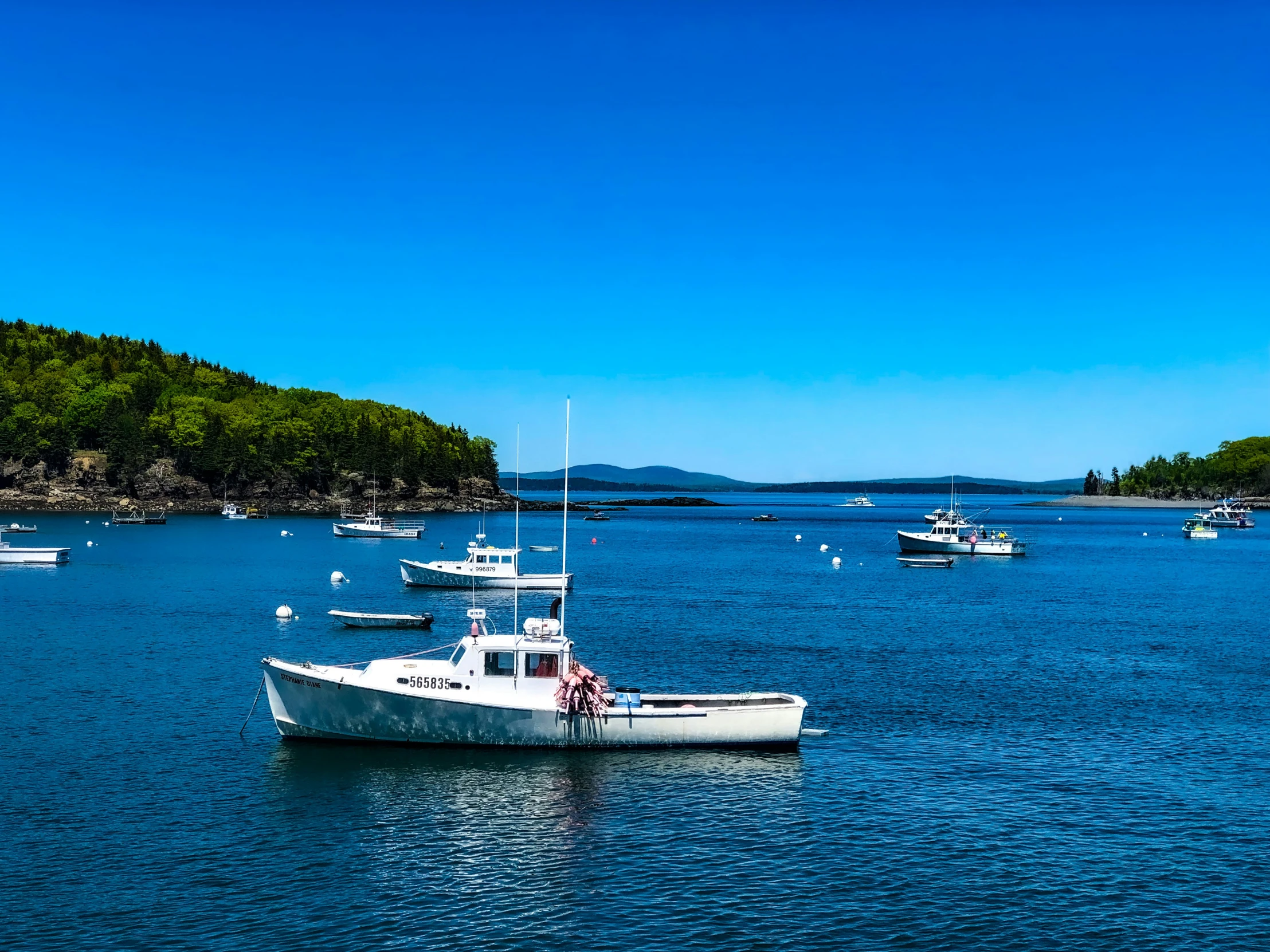 several boats floating on a large body of water