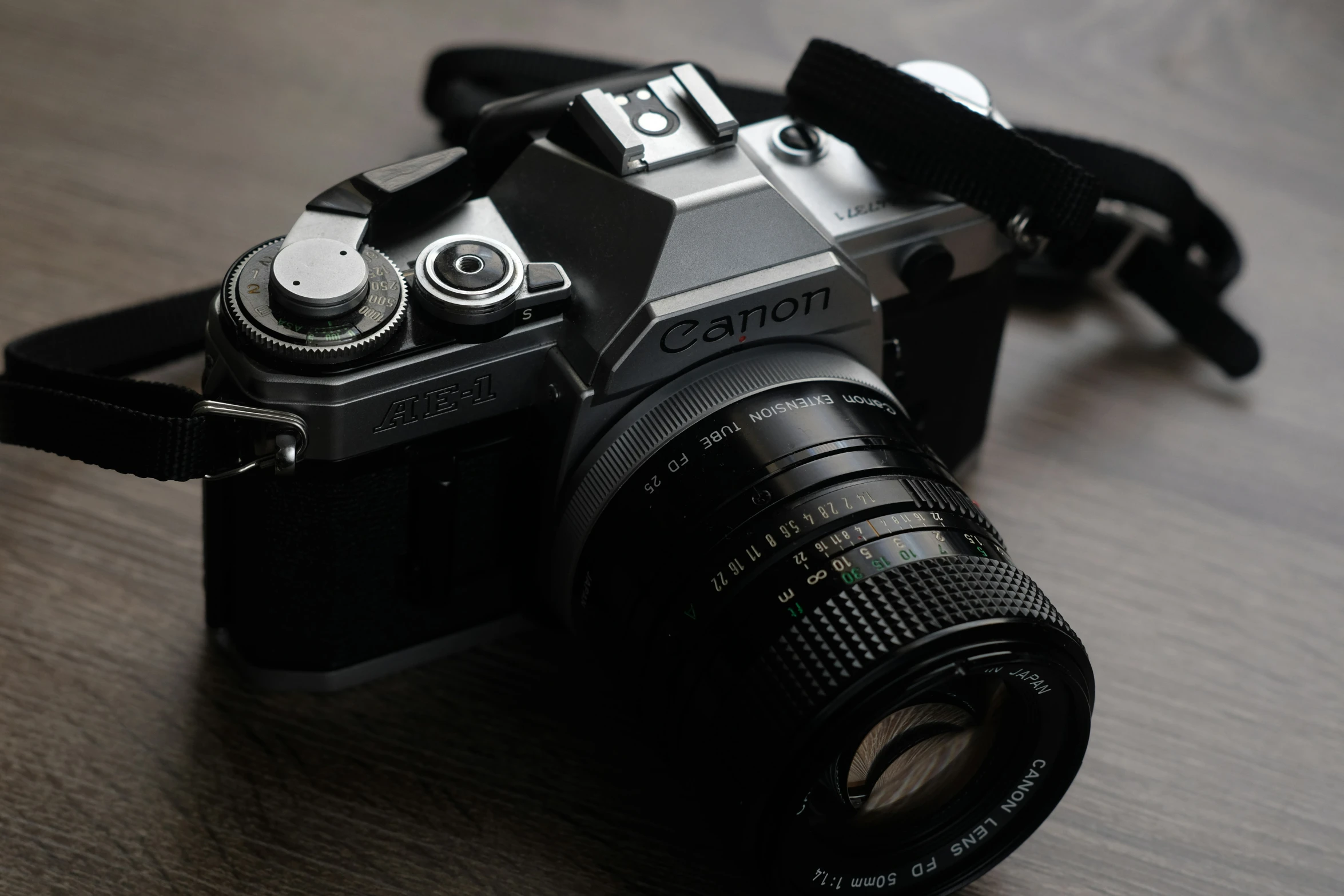 an old analog camera on a wood surface