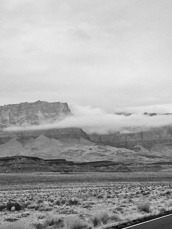 black and white pograph of clouds in the desert