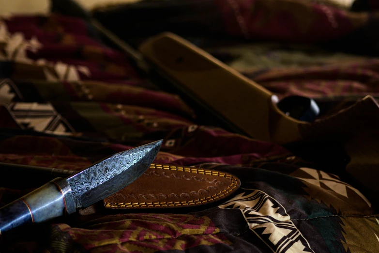 a knife is shown laying next to two wallets