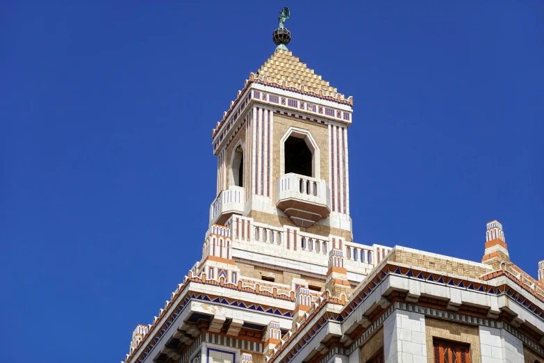 a very large white clock on a tall building