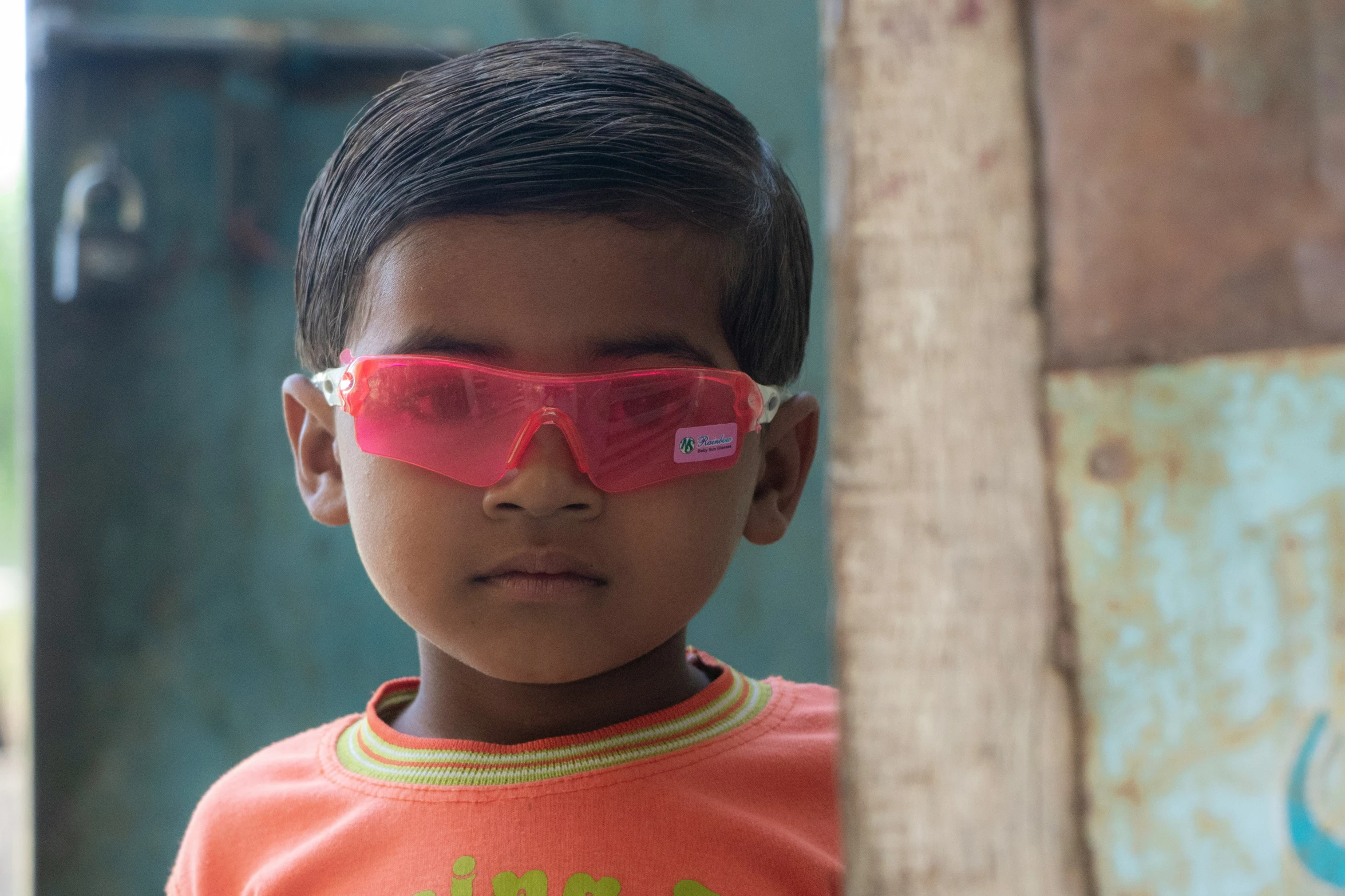 a  wearing sunglasses with pink tinted glass