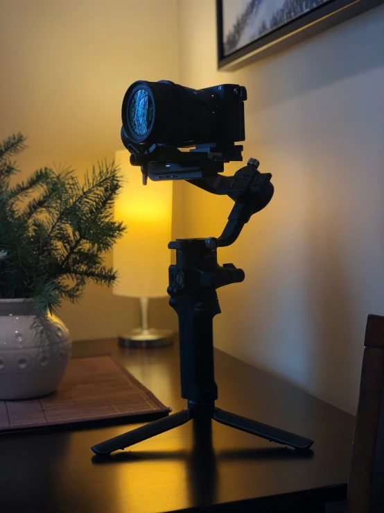 a camera with an open lens on a stand