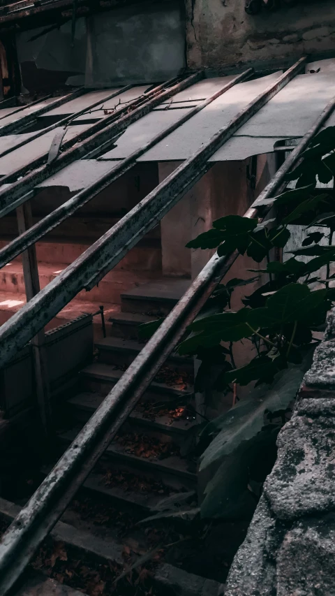 an abandoned building with metal rails extending to it's roof