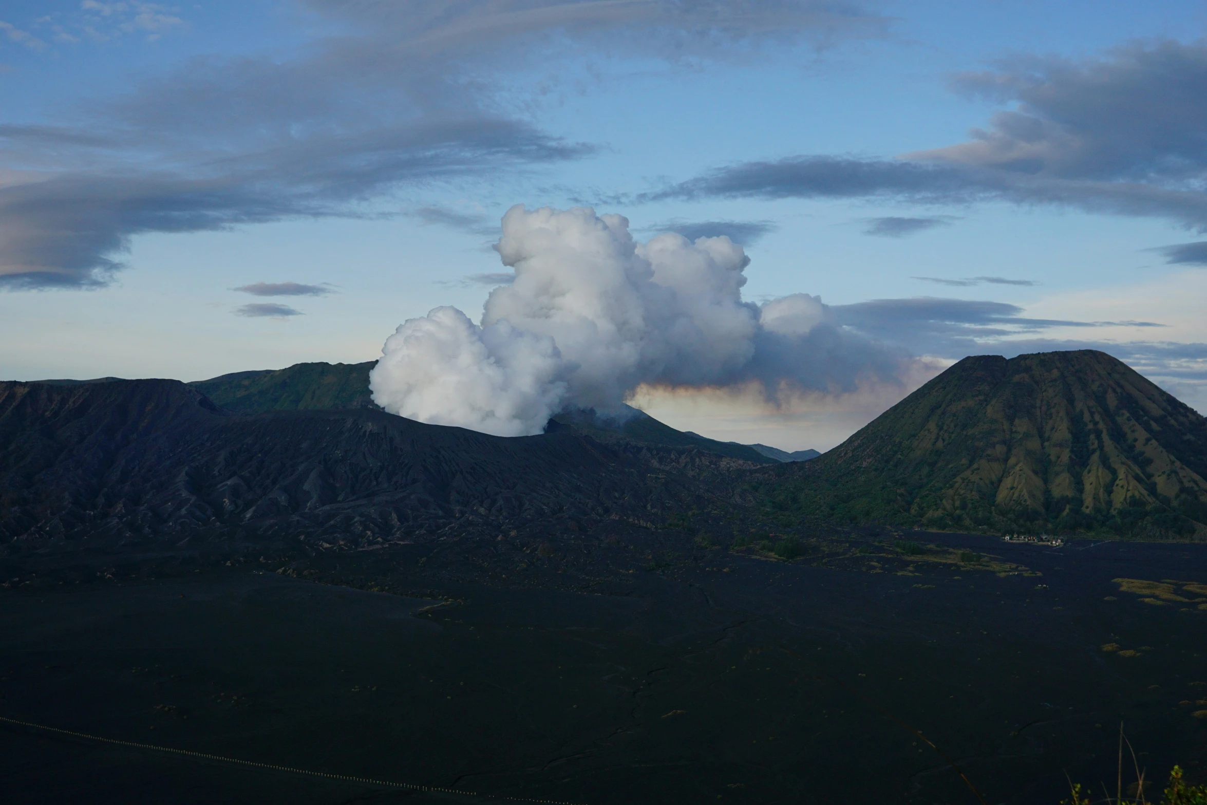 a cloud is emitting smoke into the sky