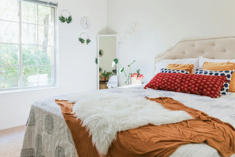 a big white bed with blankets and pillows