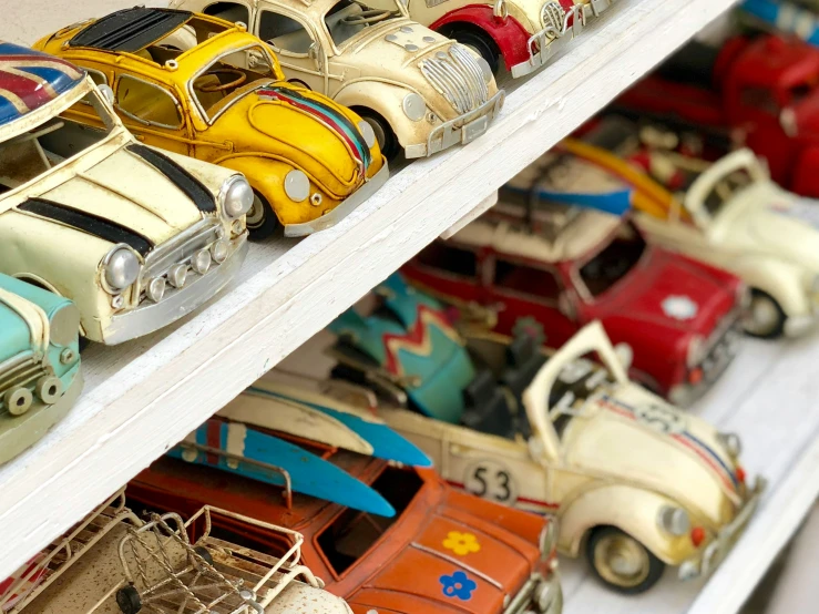 lots of colorful toy cars are lined up on a shelf