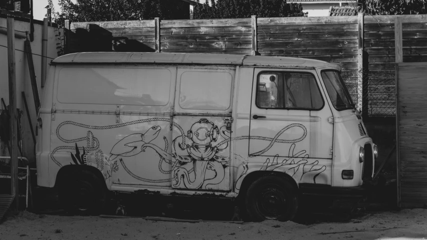 a black and white po of a truck parked next to a fence