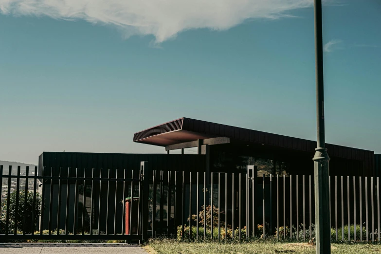 a large black fence behind a tall building