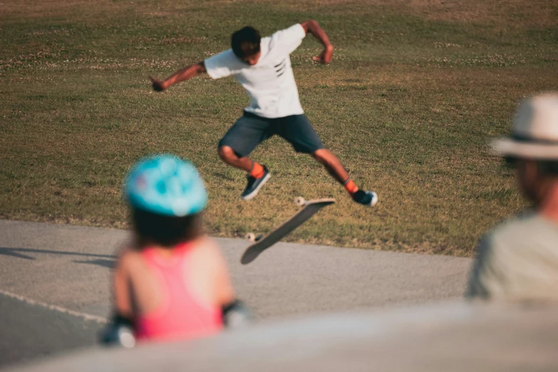 a guy doing tricks on his skateboard with the people watching him