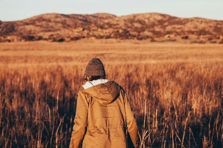 a person walking in some tall grass