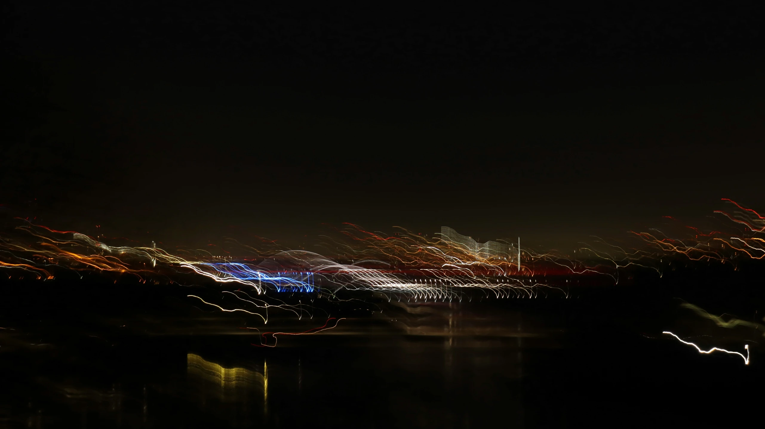 night view of city lights with water and trees