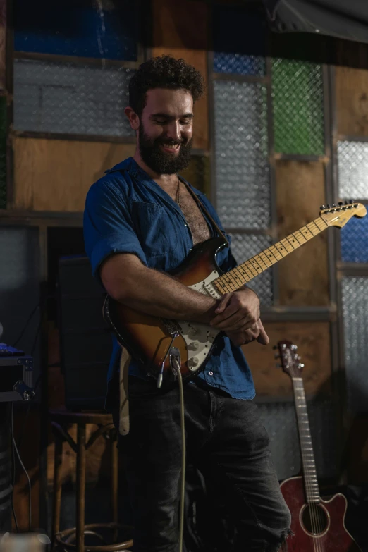 a man playing guitar in a small space