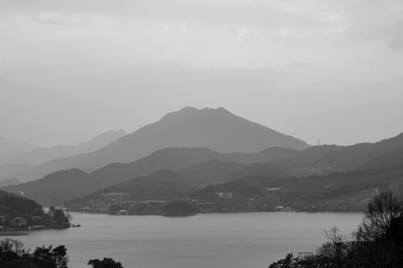 mountain, lake and small town on a misty day