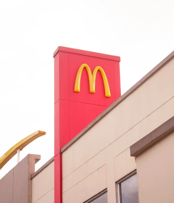 the mcdonalds restaurant is brightly painted in yellow