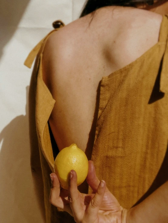 a woman holding an apple and a lemon