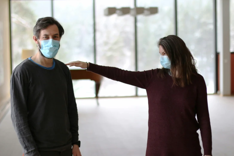 man and woman with a blue face mask