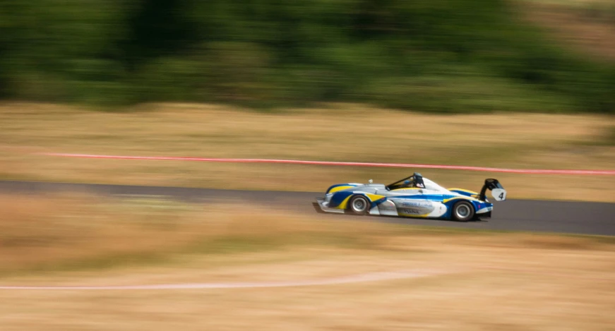 a racing car with a top down on the track