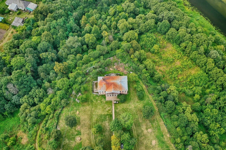 an aerial s of the back of a shack surrounded by trees