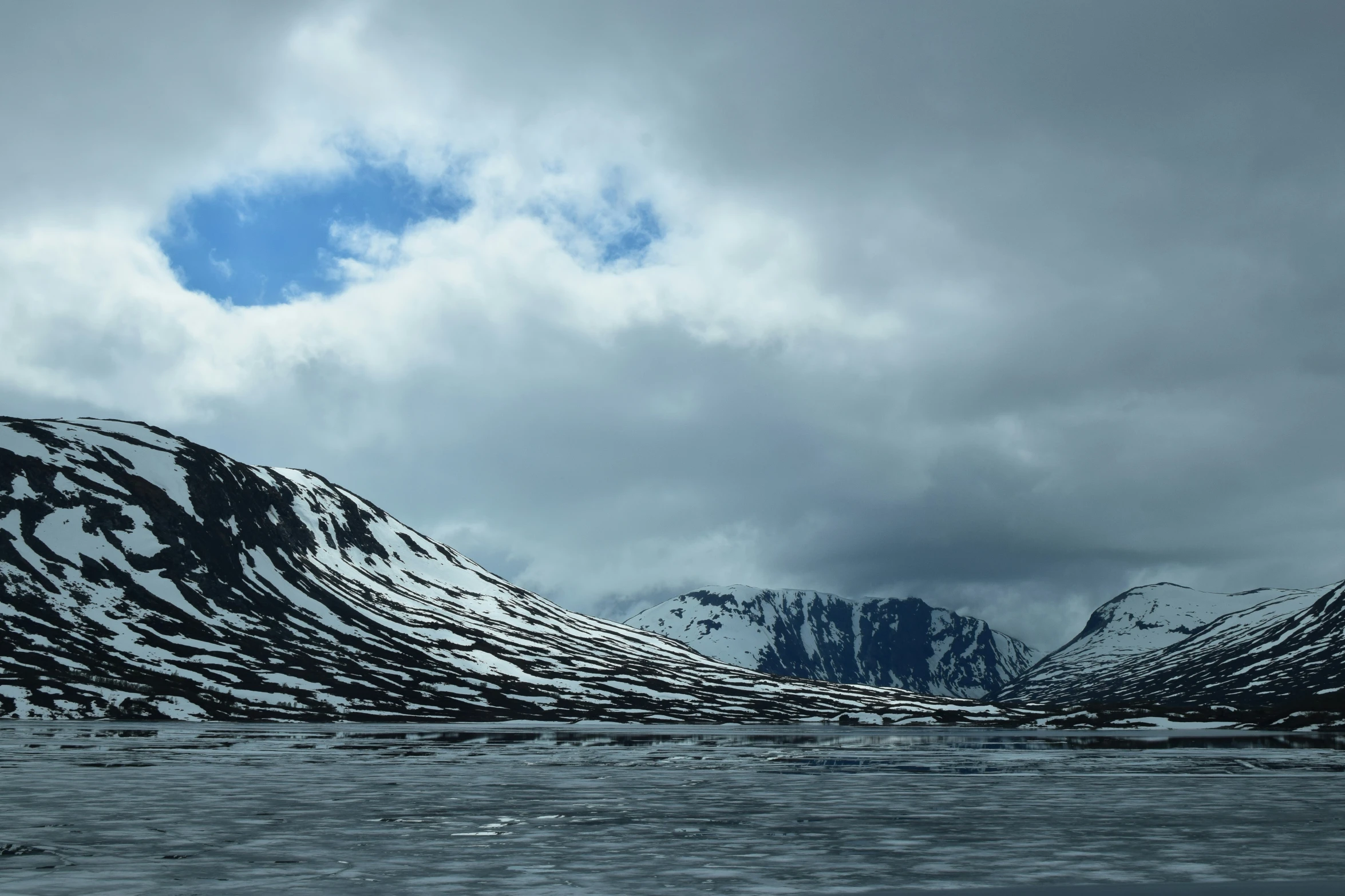 the snow covered hills are covered in thick fog