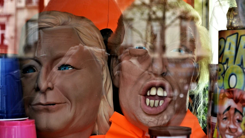 a store display with two dummy heads in the window