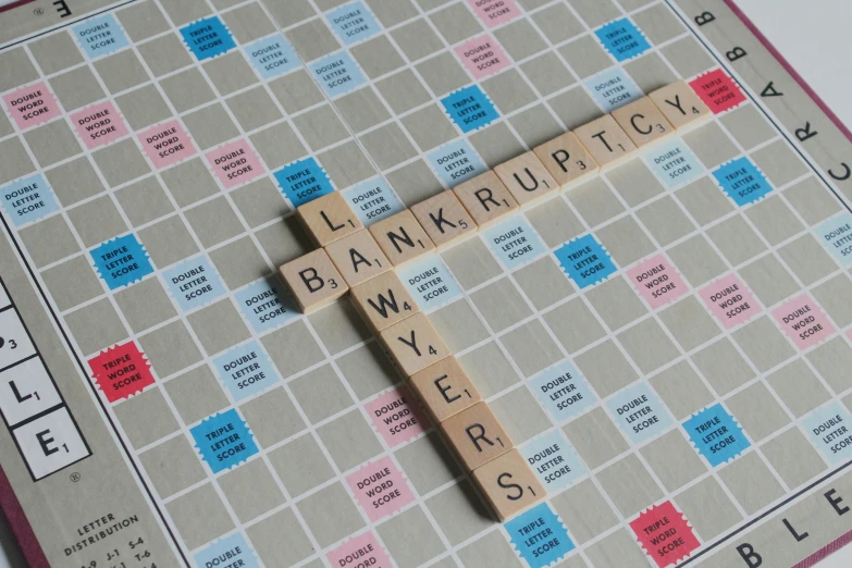 a board game with letters and pieces arranged on the board