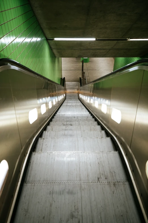 an empty subway with some kind of metal escalator