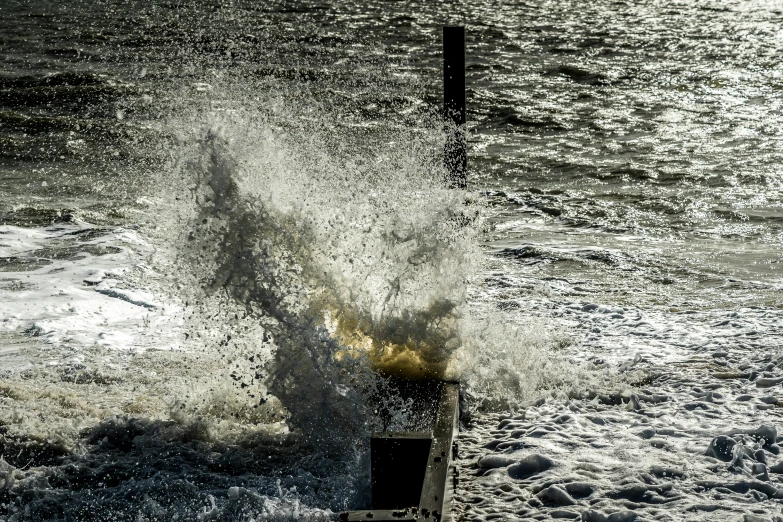 a broken fire hydrant has it's water splashing from the water